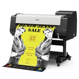 Canon printer printing a denim jeans sale advertisement on a white background